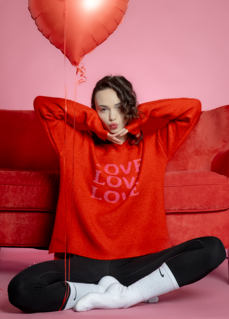 Red Valentine's Day sweater with pink 'LOVE' graphic