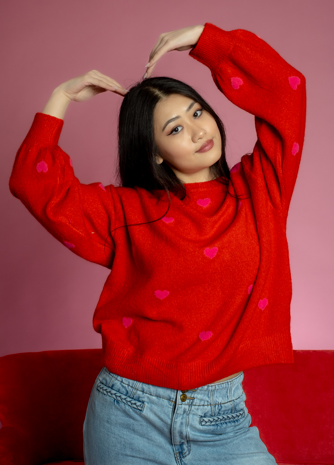 Red Valentine’s Day sweater with pink heart pattern