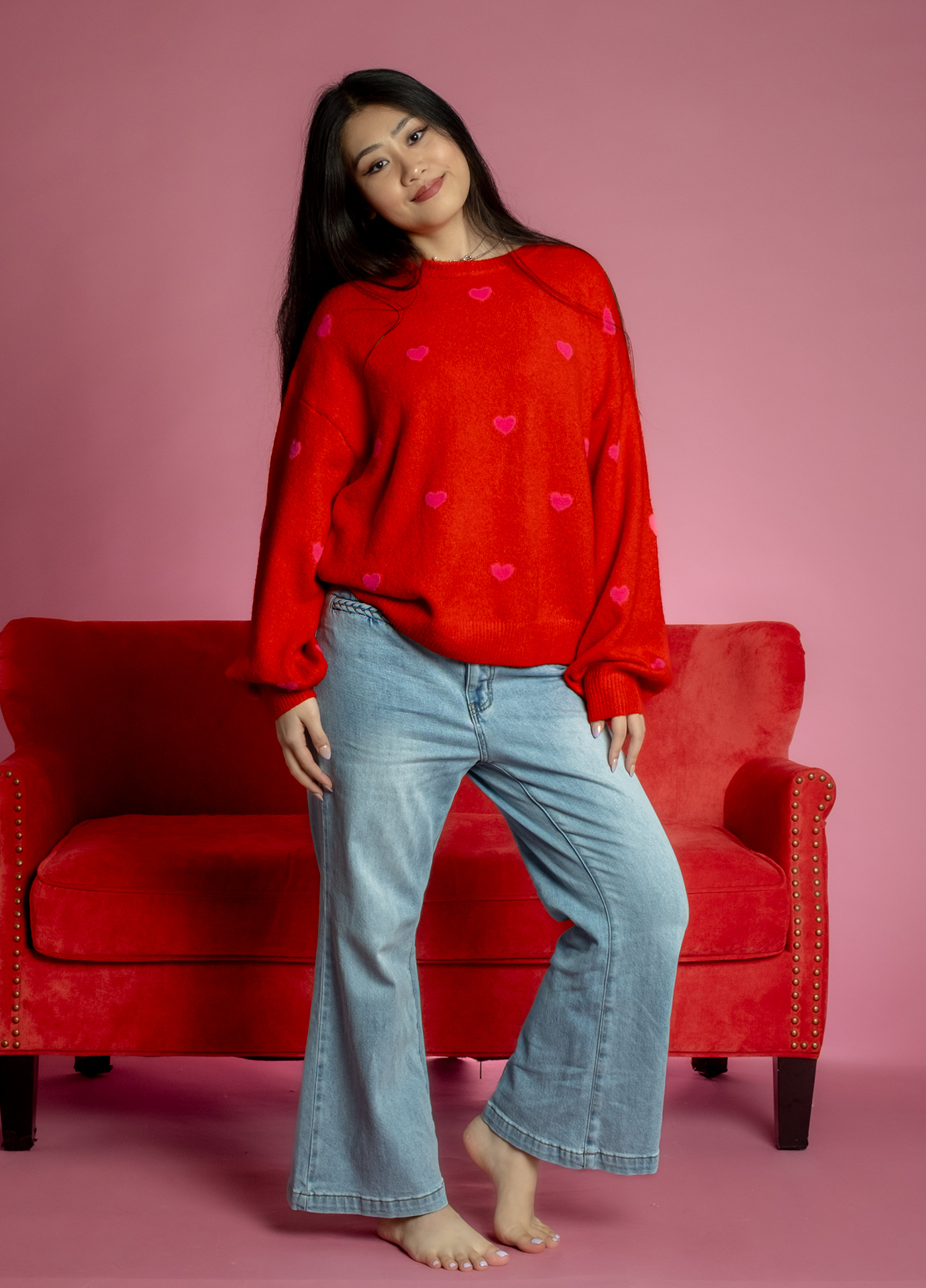 Red Valentine’s Day sweater with pink heart pattern