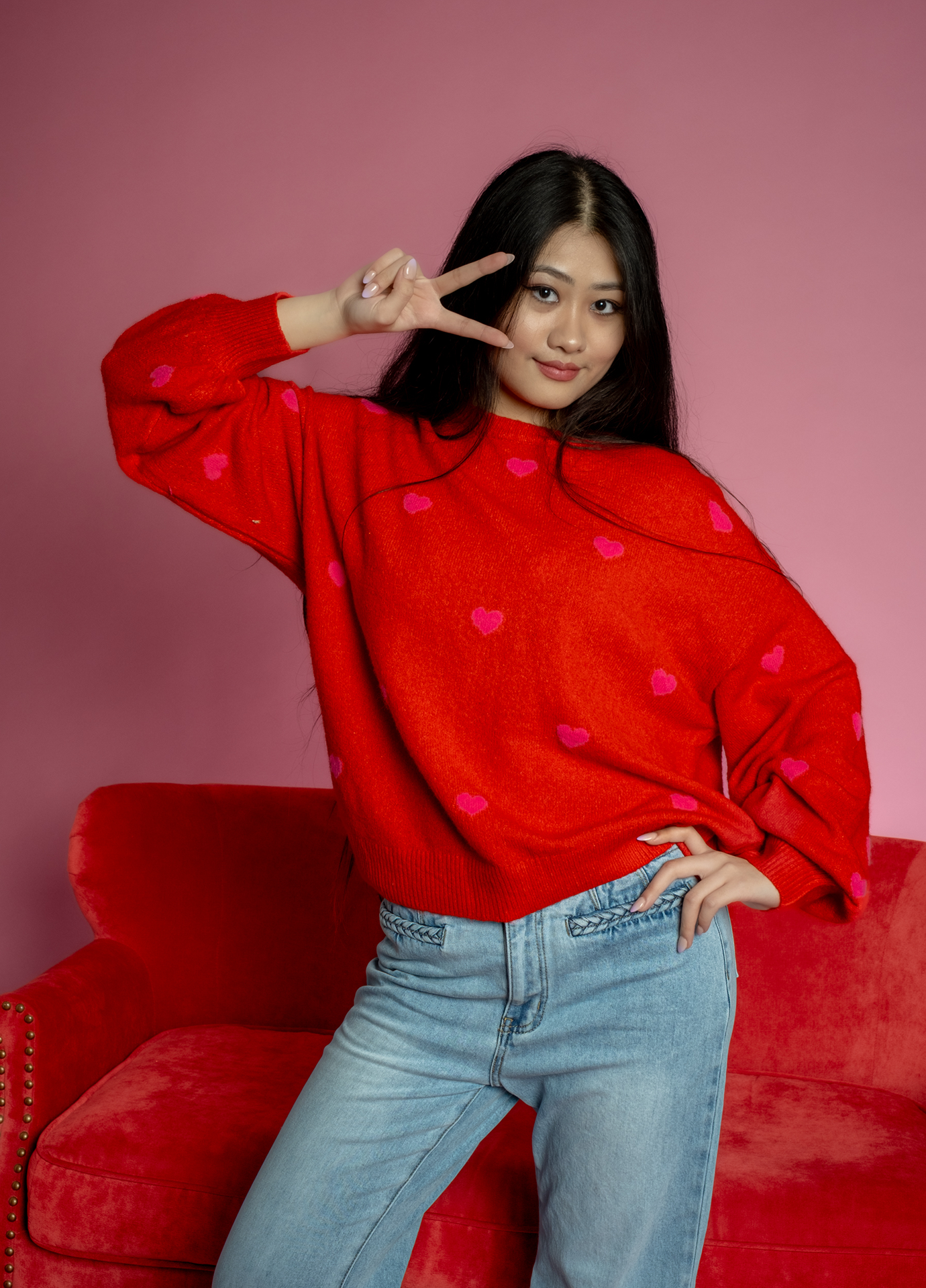 Red Valentine’s Day sweater with pink heart pattern