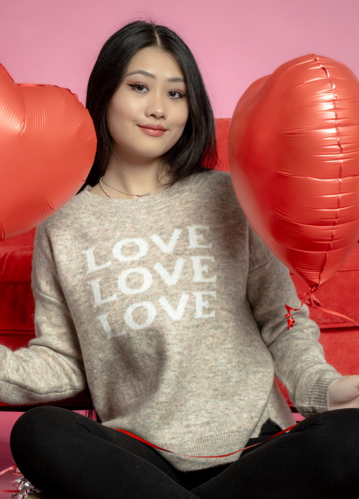 Oatmeal beige Valentine's Day sweater with white "LOVE" graphic, cozy relaxed fit